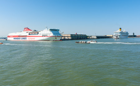 Venice Italy - May 10 2011; Minoan Line high-speed ferry and cruise ship in port under clear blue sky.のeditorial素材