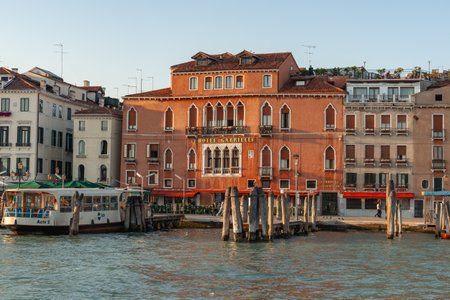 Venice Italy - May 10 2011;  Waterfront and ferry outside red brick Hotel Gabrielli .のeditorial素材