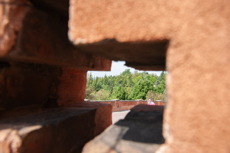 Bologna Italy - May11 2011 Woman in view through cross-shaped openings in thick walls of Portico of San Luca, Bologna.のeditorial素材