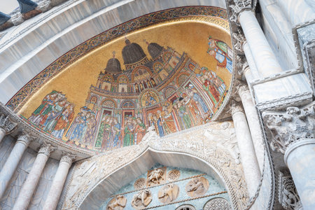Venice Italy - May 11 2011; Religious mosaic scene in niche of arch on exterior of St Marks cathedral.のeditorial素材
