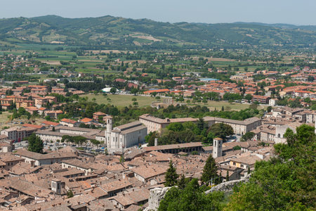 Rooftops showing closeness of homes and landscape of old Italian walled city of Gubbio on mountainside of Mt. Ingino.の写真素材