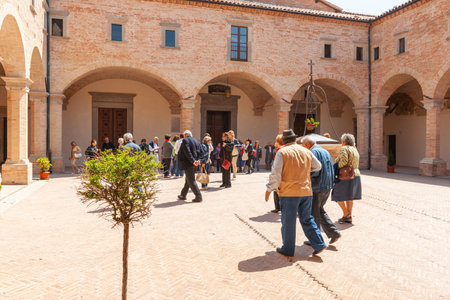 Gubio Umbria, Italy, May 12 2011; Tourists in courtyard of medieval basilica of Saint Ubaldo.のeditorial素材
