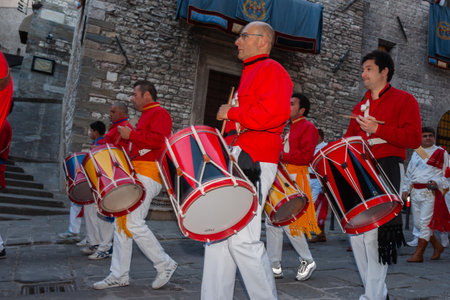 Gubbio Umbria, Italy-May 15 2011; Drummers in red uniform march playing in street during annual evening celebration of Festa dei Ceriのeditorial素材