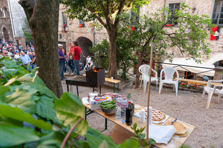 Gubbio Umbria, Italy-May 15 2011; Editorial-Table set with food ready for preparation for celebrations outdoors.のeditorial素材