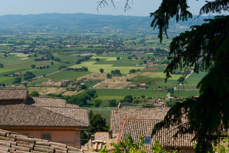 Landscape view from high vantage point over tiled roofs of village homes in Assissiの写真素材