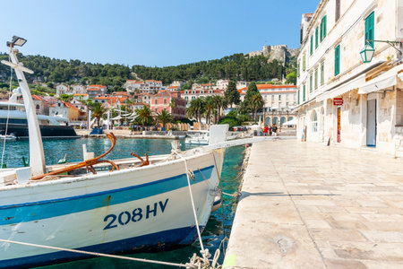 Hvar Croatia - May 27 2011; Editorial-Hvar waterfront walk with surrounding township and castle on hill.のeditorial素材