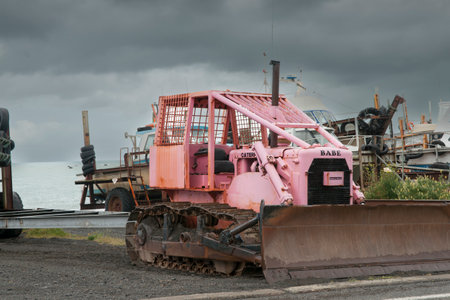Ngawi New Zealand - November 29 2011; Old pink Caterpillar tractor named Babe used to tow boast to and from seaのeditorial素材