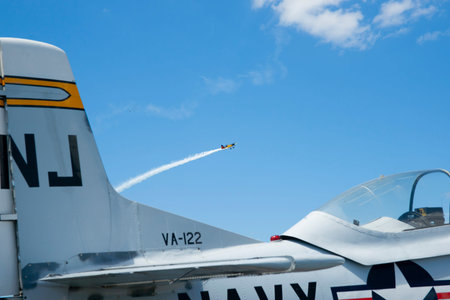 Tauranga New Zealand - January 28 2012; Open plane close and in foreground and vapor trail from...