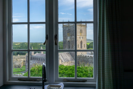 View through multi-paned window over St David's Cathedral and Pembrokeshire rural landscape beyond...