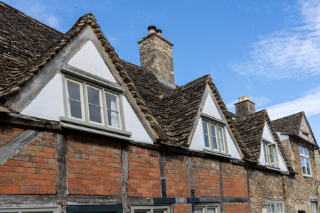 Dormer roof and windows example in row on half-timbered brick house in United Kingdom.の写真素材
