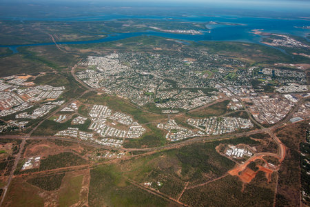 Aerial city shots leaving Darwin to fly south west along coastの写真素材