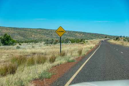 Western Australia Australia - May 11 2025; One of frequent Floodway signs while Travelling Great Northern Highway  ahead lthrough rural and remote landscape leading to Gibb River Roadの写真素材
