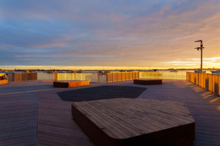 Tauranga waterfront walkway and lookout back-lit by sunrise with patterns and shadow effects.