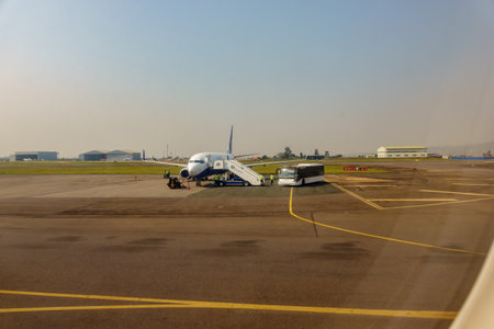 Kigali Rwanda - September 9 2025; African RwandAir passenger plane parked at International airport in middle of airport apron being readied for travel in hazy atmosphere around airport.のeditorial素材