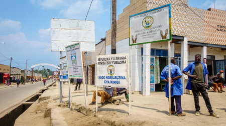 Kningi Rwanda - September 2025; Men standing around in street outside Republic of Rwanda Ministry of Health Kinigi Health Center.のeditorial素材