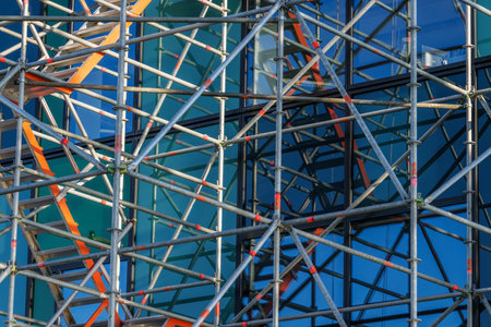 Construction pattern of scaffolding on side of glass exterior of a buildingの写真素材