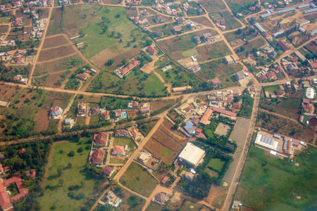 Aerial red rooftops below through passenger plane window in flight over Kigali  Rwanda.の写真素材