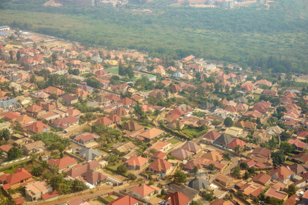 Aerial red rooftops below through passenger plane window in flight over Kigali  Rwanda.の写真素材