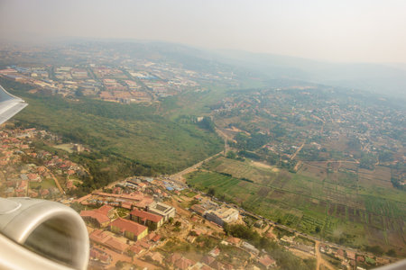 Aerial red rooftops below through passenger plane window in flight over Kigali  Rwanda.の写真素材