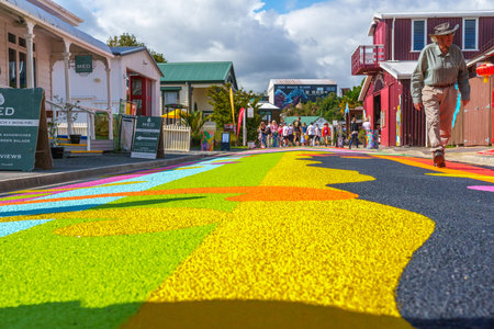 Tauranga April 3 2026;  Visitors on Tauranga Historic Village brightly patterned and painted street.