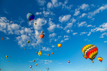 Hot Air Balloons fly over the city of Albuquerque, New Mexico during the mass ascension at the annual International Hot Air Balloon Fiesta in October, 2016のeditorial素材