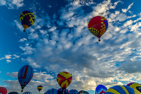 Hot Air Balloons fly over the city of Albuquerque, New Mexico during the mass ascension at the annual International Hot Air Balloon Fiesta in October, 2016のeditorial素材