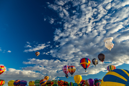 Hot Air Balloons fly over the city of Albuquerque, New Mexico during the mass ascension at the annual International Hot Air Balloon Fiesta in October, 2016のeditorial素材