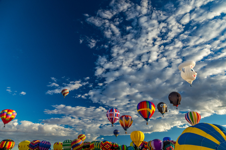 Hot Air Balloons fly over the city of Albuquerque, New Mexico during the mass ascension at the annual International Hot Air Balloon Fiesta in October, 2016のeditorial素材