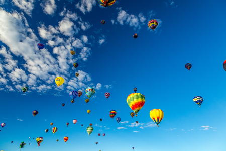 Hot Air Balloons fly over the city of Albuquerque, New Mexico during the mass ascension at the annual International Hot Air Balloon Fiesta in October, 2016のeditorial素材