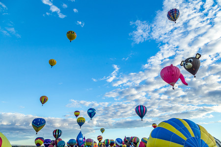 Hot Air Balloons fly over the city of Albuquerque, New Mexico during the mass ascension at the annual International Hot Air Balloon Fiesta in October, 2016のeditorial素材