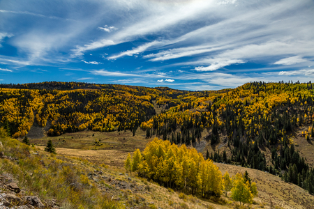 Beautiful mountain scenery with streams, valleys, and color changing trees along a train route from Chama, New Mexico to Antonito, Coloradoの写真素材