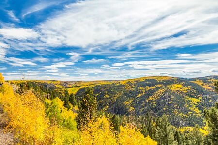 Beautiful mountain scenery with streams, valleys, and color changing trees along a train route from Chama, New Mexico to Antonito, Coloradoの写真素材
