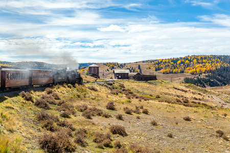 A Cumbres & Toltec steam locomotive arrives at Osier Station with a passenger train traveling through the San Juan National Forest on a trip from Chama, New Mexico through a beautiful scenic mountain route ending in Antonito, Coloradoのeditorial素材