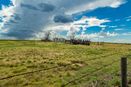 An empty building sits abandoned as a summer storm approaches near the Colorado Kansas state line on Us Highway 50.の写真素材