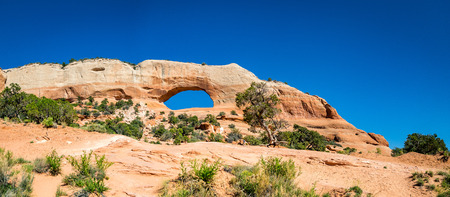 Located outside of Moab, Utah is a natural bridge that has formed through the act of wind and water erosion, causing a beautiful archway.の写真素材