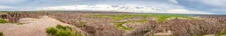 Badlands National Park is located in southwestern South Dakota, featuring nearly 400 square miles of sharply eroded buttes and pinnacles, and the largest undisturbed mixed grass prairie in the United States.の写真素材