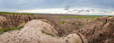Badlands National Park is located in southwestern South Dakota, featuring nearly 400 square miles of sharply eroded buttes and pinnacles, and the largest undisturbed mixed grass prairie in the United States.の写真素材