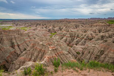 Badlands National Park is located in southwestern South Dakota, featuring nearly 400 square miles of sharply eroded buttes and pinnacles, and the largest undisturbed mixed grass prairie in the United States.の写真素材