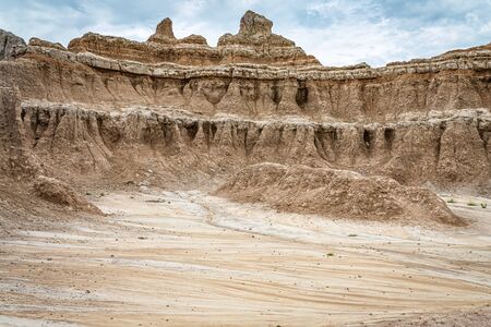 Badlands National Park is located in southwestern South Dakota, featuring nearly 400 square miles of sharply eroded buttes and pinnacles, and the largest undisturbed mixed grass prairie in the United States.の写真素材