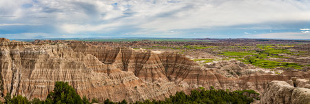 Badlands National Park is located in southwestern South Dakota, featuring nearly 400 square miles of sharply eroded buttes and pinnacles, and the largest undisturbed mixed grass prairie in the United States.の写真素材