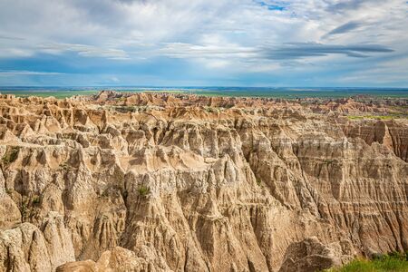Badlands National Park is located in southwestern South Dakota, featuring nearly 400 square miles of sharply eroded buttes and pinnacles, and the largest undisturbed mixed grass prairie in the United States.の写真素材