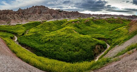 Badlands National Park is located in southwestern South Dakota, featuring nearly 400 square miles of sharply eroded buttes and pinnacles, and the largest undisturbed mixed grass prairie in the United States.の写真素材