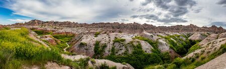 Badlands National Park is located in southwestern South Dakota, featuring nearly 400 square miles of sharply eroded buttes and pinnacles, and the largest undisturbed mixed grass prairie in the United States.の写真素材