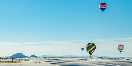 White Sands National Monument, NM / USA - September 18, 2016: Colorful hot air ballons take to the sky at the 25th Annual White Sands Hot Air Balloon Invitational.のeditorial素材