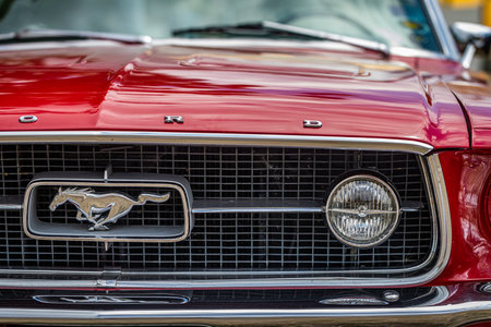 Des Moines, IA - July 03, 2022: Close up detail view of a 1965 Ford Mustang GT Coupe headlight and grille at a local car show.のeditorial素材