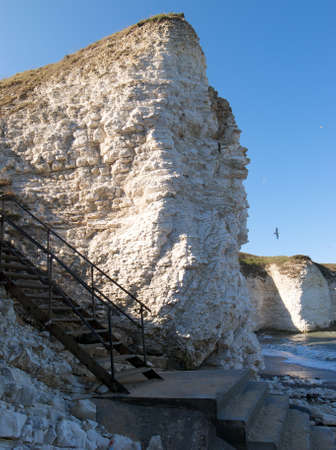 Steps leading to flamborough head beach. White chaulk cliffs.の写真素材