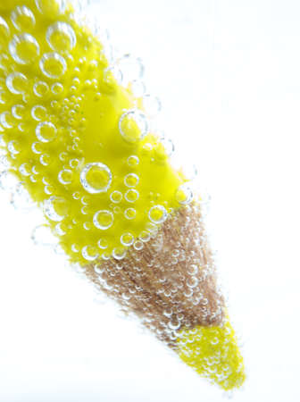 yellow pencil on white background,with bubblesの写真素材