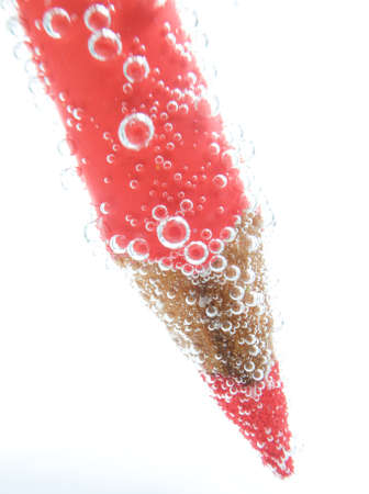red pencil crayon on white background with bubblesの写真素材