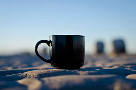 A blank black coffee mug on the dirty ground floor of the great salt lake.の写真素材