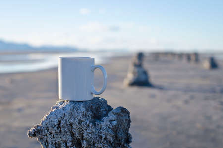 A single blank white coffee mug on the side of a old post on the pier of the great salt lake historic sight.の写真素材